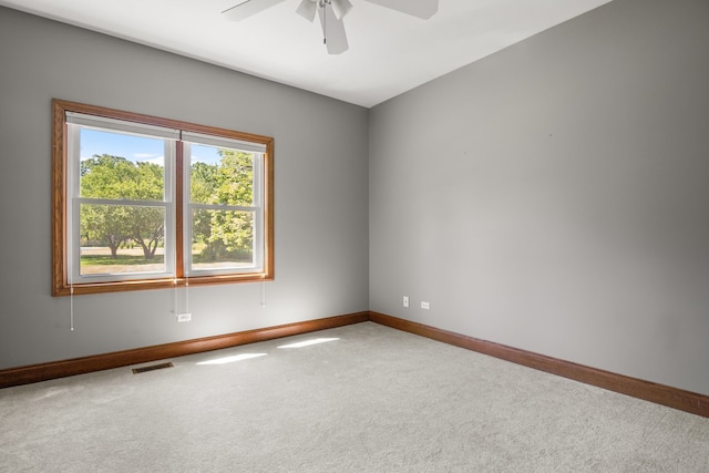 empty room with ceiling fan and carpet