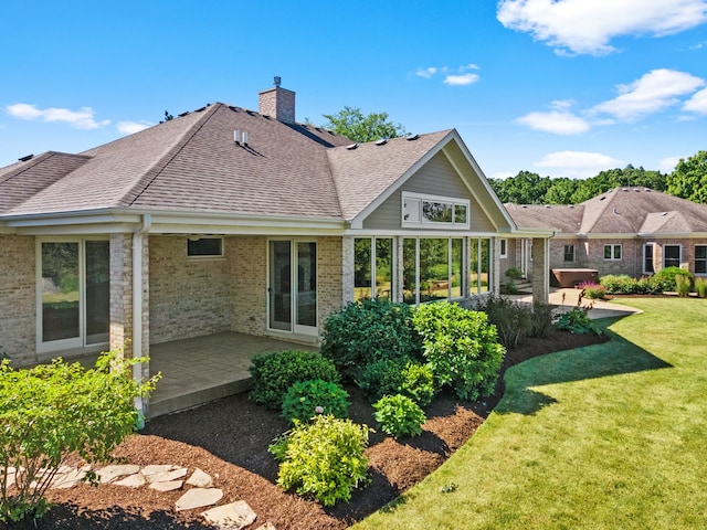 rear view of property featuring a patio and a yard