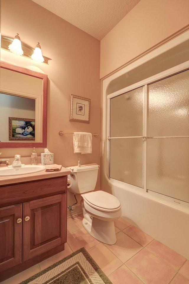 17619 Grandview Dr, Sterling, IL 61081 - bathroom featuring tile patterned floors, toilet, vanity, a textured ceiling, and enclosed tub / shower combo