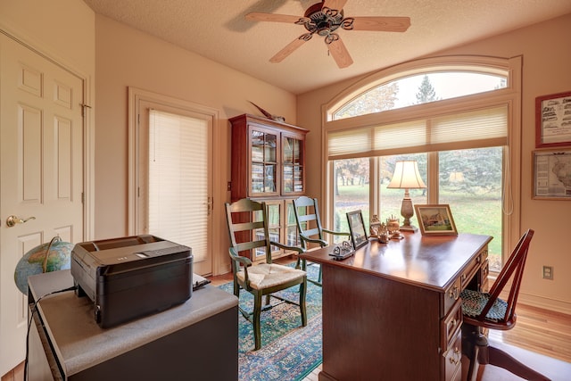 office with hardwood / wood-style floors, ceiling fan, and a textured ceiling