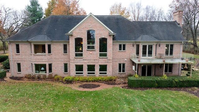 17619 Grandview Dr, Sterling, IL 61081 - back of house featuring a chimney, a yard, brick siding, and a balcony