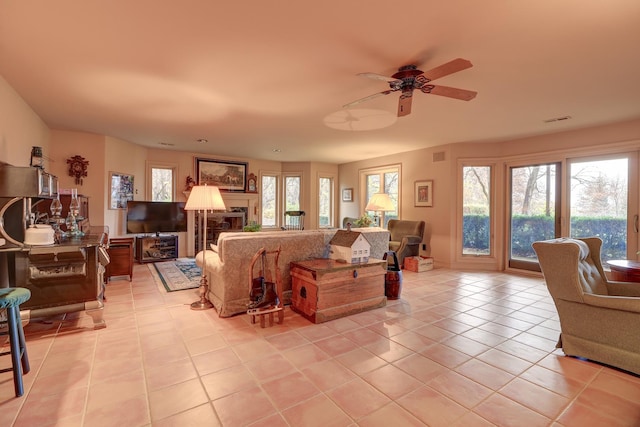 17619 Grandview Dr, Sterling, IL 61081 - living room with light tile patterned flooring, ceiling fan, and a fireplace