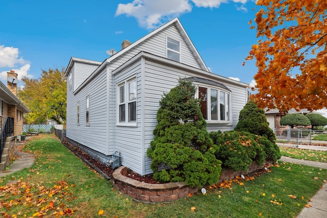 view of home's exterior with a yard