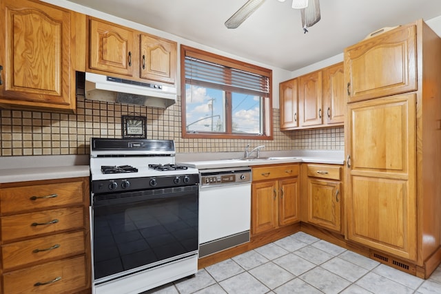 kitchen featuring white appliances, sink, ceiling fan, tasteful backsplash, and light tile patterned flooring