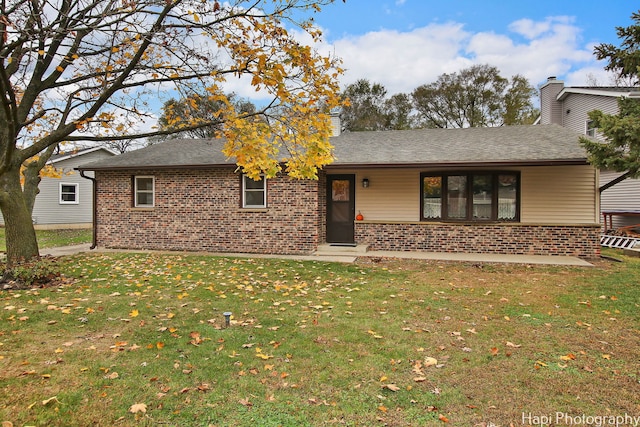 rear view of property featuring a yard