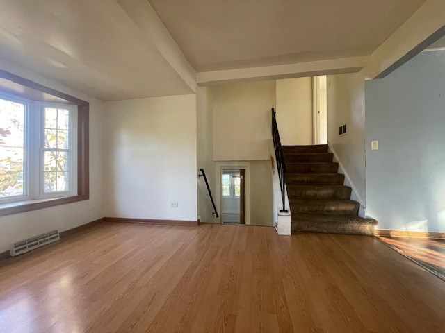 stairs with hardwood / wood-style flooring