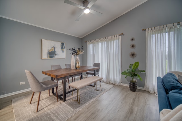 dining area featuring ceiling fan, crown molding, light hardwood / wood-style flooring, and vaulted ceiling