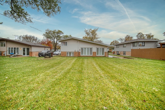 rear view of property featuring a yard