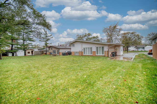 rear view of property featuring a yard