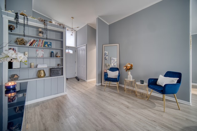 sitting room featuring light wood-type flooring and high vaulted ceiling