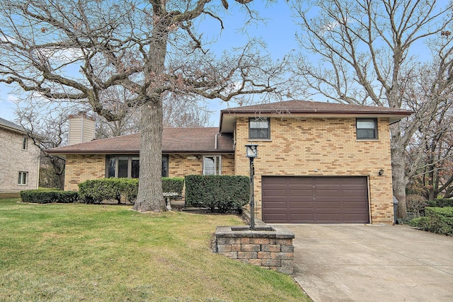 split level home featuring a garage and a front lawn