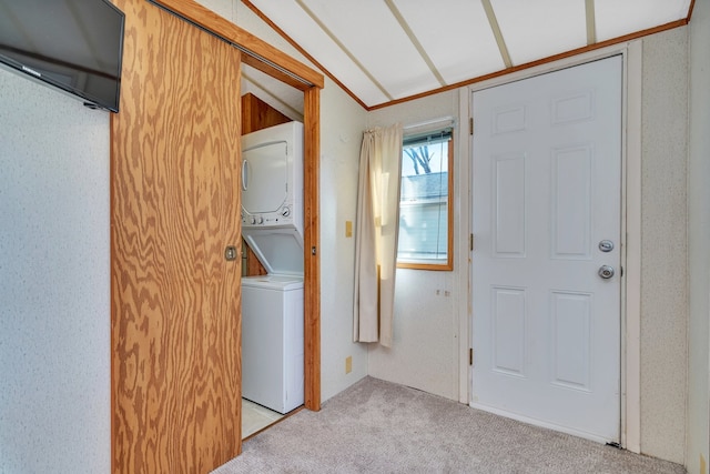 laundry area featuring light colored carpet and stacked washer / dryer