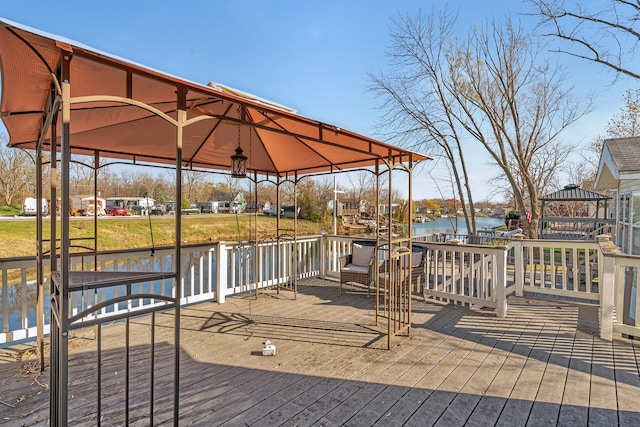 deck featuring a gazebo and a water view