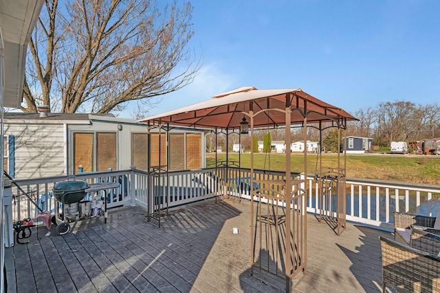 wooden terrace featuring a yard, area for grilling, and a gazebo