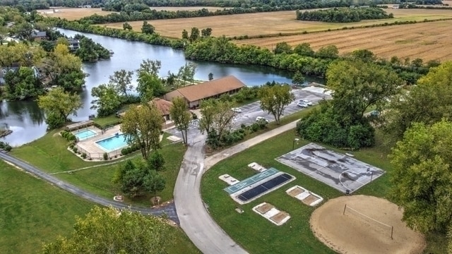 drone / aerial view featuring a water view and a rural view