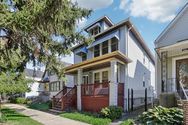 american foursquare style home featuring a porch