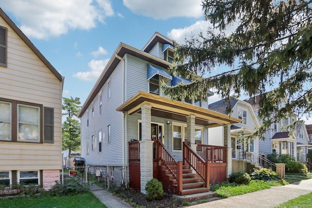 american foursquare style home featuring a porch and a gate