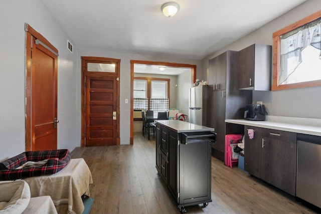 kitchen featuring visible vents, stainless steel appliances, light countertops, and light wood-style floors