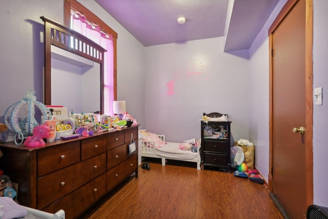 bedroom with wood finished floors