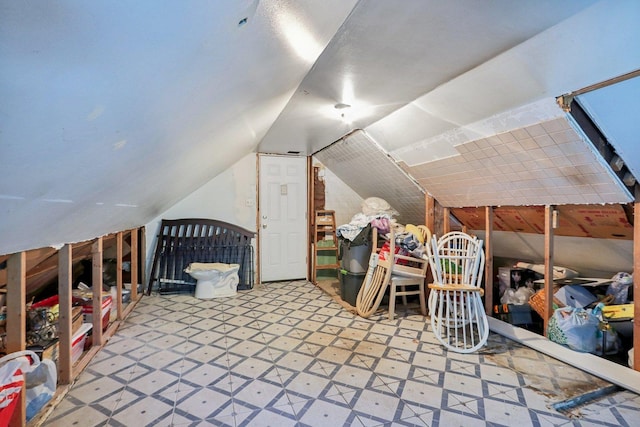 interior space featuring tile patterned floors and vaulted ceiling