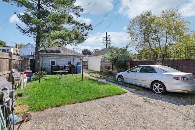 view of yard with an outbuilding and fence