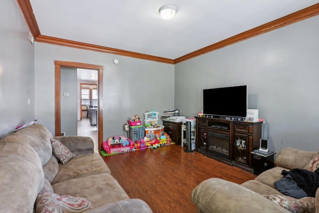 living area featuring crown molding and wood finished floors