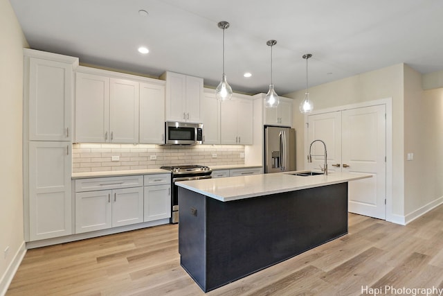 kitchen with white cabinetry, sink, and stainless steel appliances