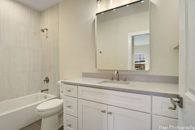 full bathroom featuring toilet, tiled shower / bath combo, and vanity