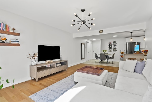 living room with wood-type flooring and a notable chandelier