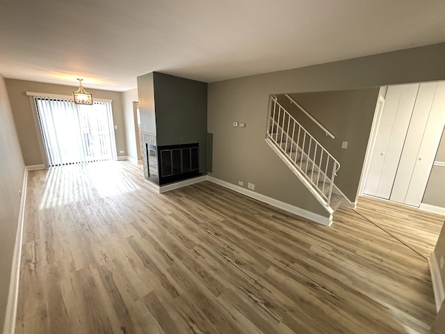 unfurnished living room with wood-type flooring