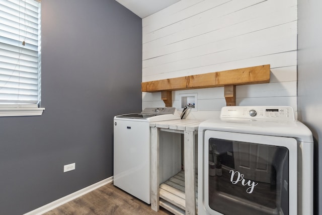 washroom featuring a healthy amount of sunlight, washer and dryer, and dark hardwood / wood-style floors