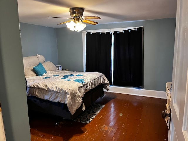 bedroom featuring ceiling fan and dark hardwood / wood-style floors