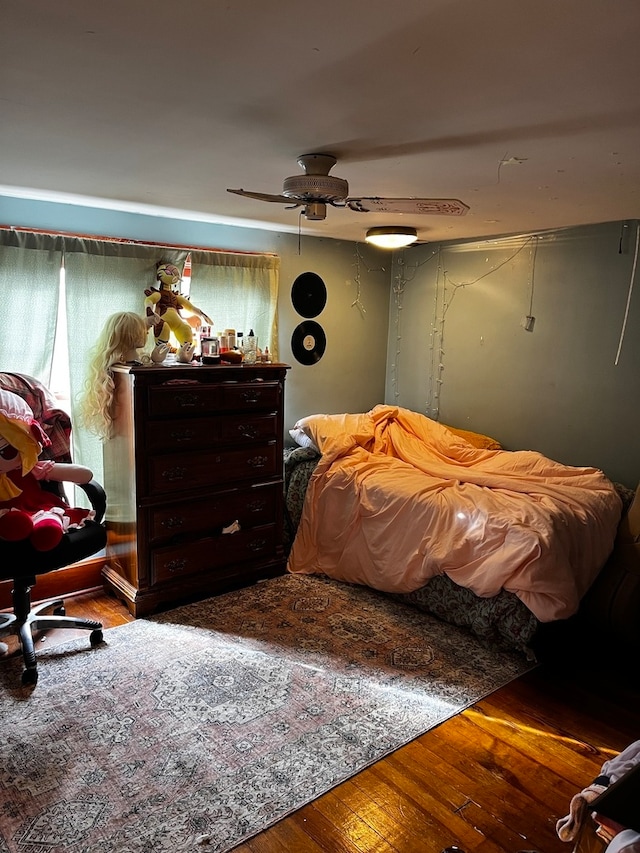 bedroom with hardwood / wood-style floors and ceiling fan