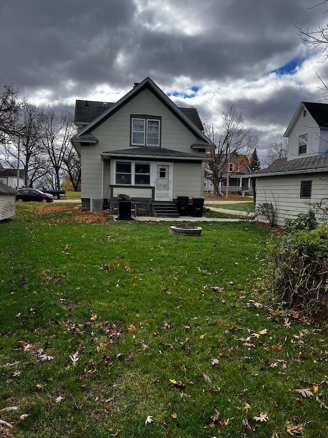 rear view of house with a yard