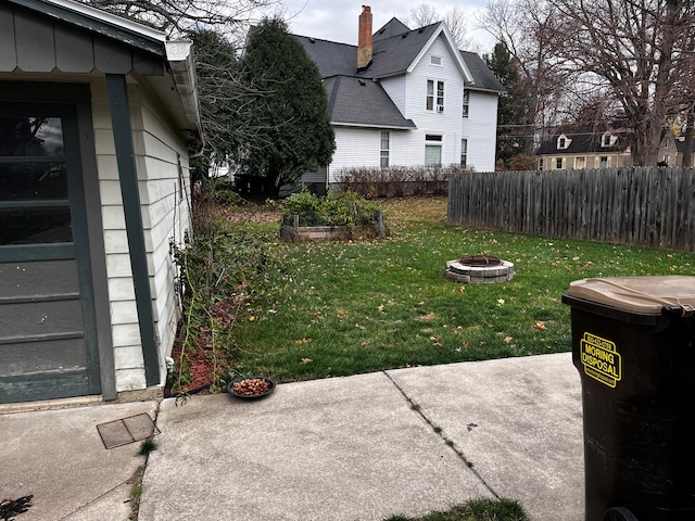 view of yard with a patio and an outdoor fire pit