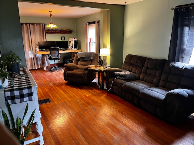 living room with built in desk and wood-type flooring