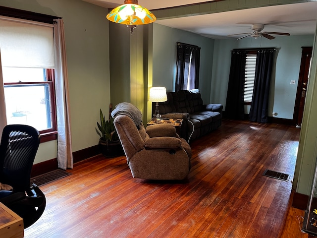 living room with hardwood / wood-style flooring and ceiling fan