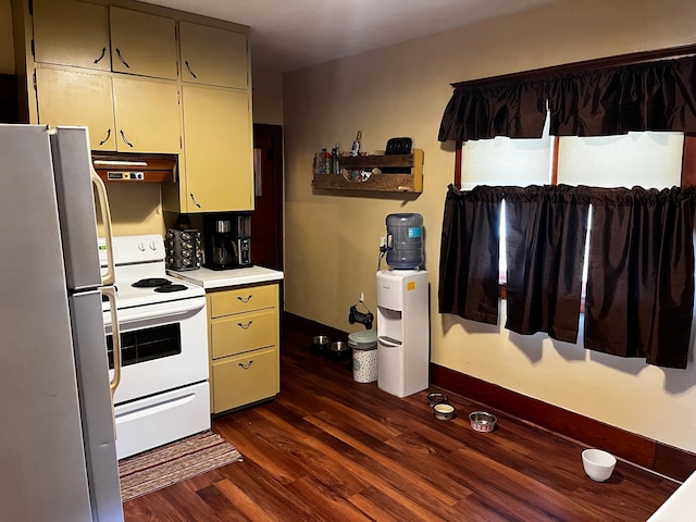 kitchen with dark hardwood / wood-style flooring and white appliances