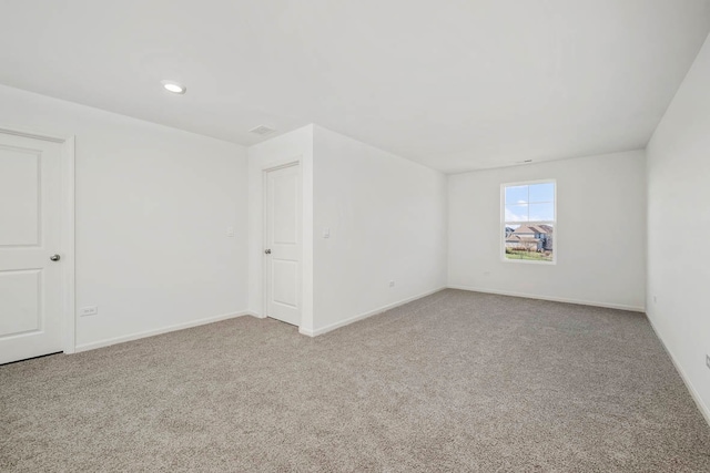 spare room with light colored carpet