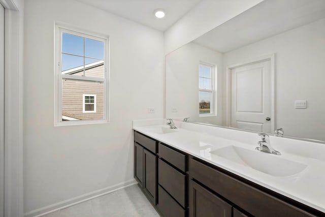 bathroom with tile patterned flooring, vanity, and a wealth of natural light