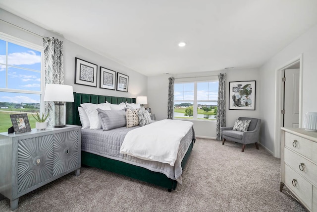 carpeted bedroom featuring multiple windows