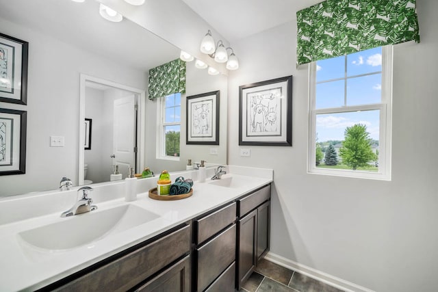 bathroom featuring tile patterned floors, vanity, and toilet