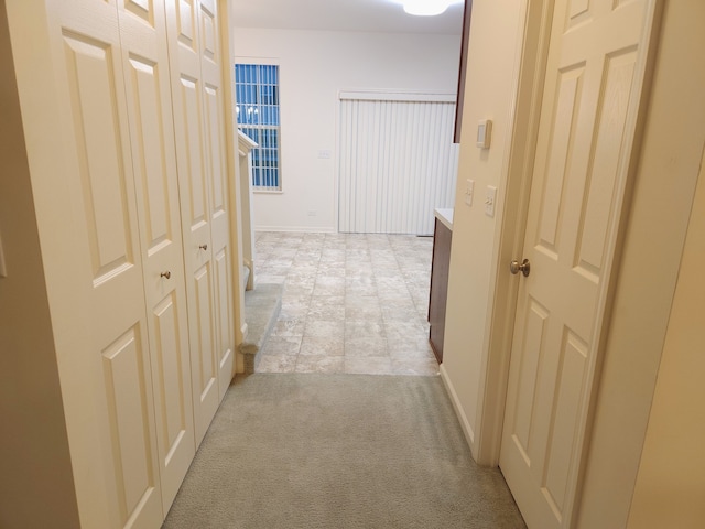 hallway with light colored carpet