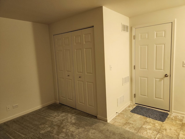 interior space with light carpet and a closet