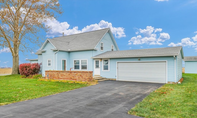 front facade featuring a front yard and a garage