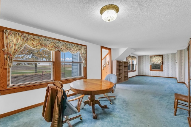 dining room featuring carpet and a textured ceiling