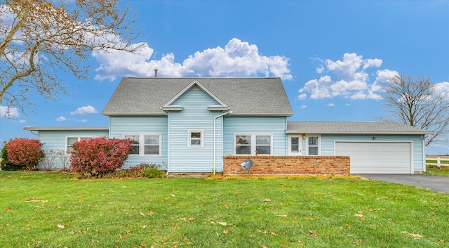 view of front of home with a front lawn and a garage