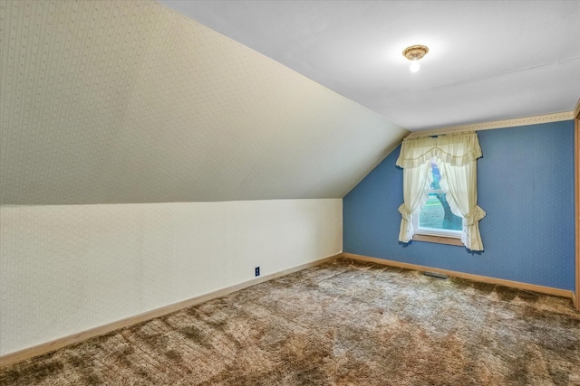 bonus room with lofted ceiling and carpet floors