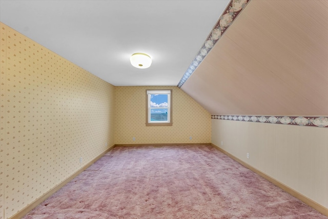 additional living space with carpet floors and lofted ceiling