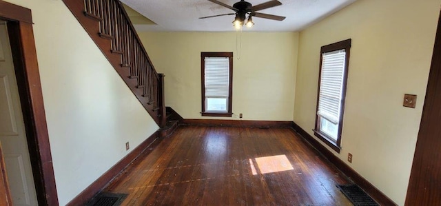 spare room featuring dark hardwood / wood-style floors and ceiling fan